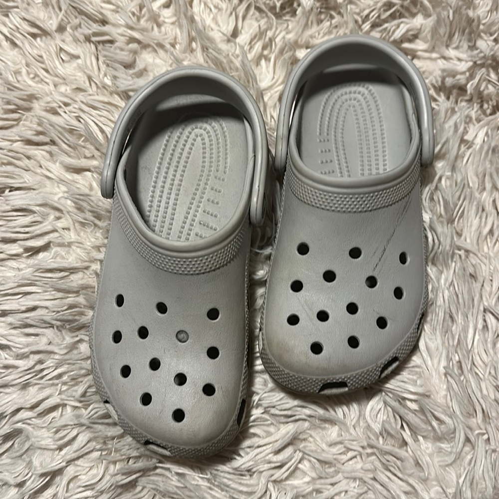 Light gray kids crocs size J4.